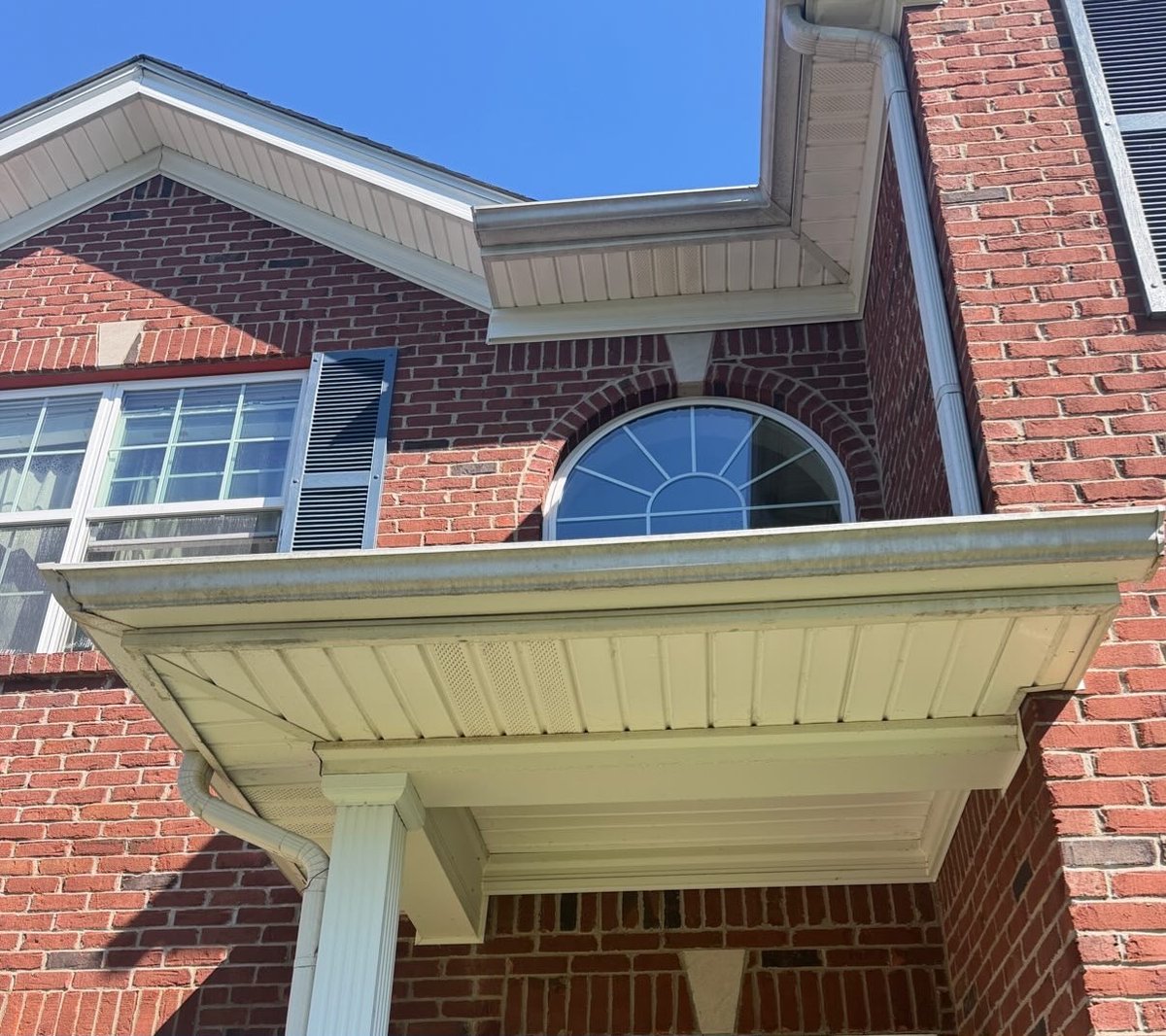 Brick home soffit before soft washing in Central Kentucky