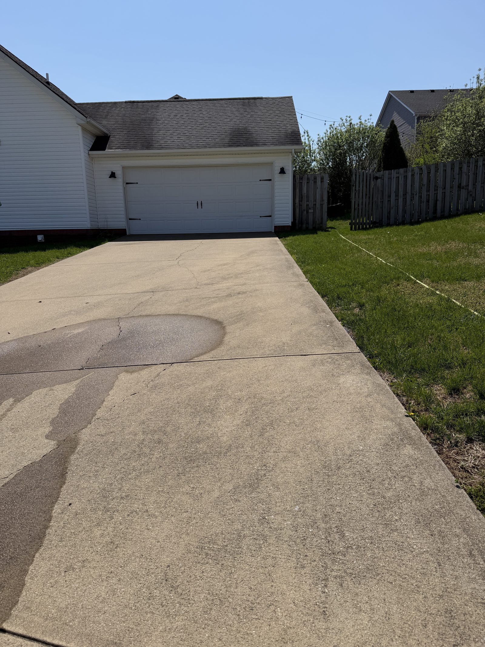 Concrete driveway with mildew and stains before pressure washing