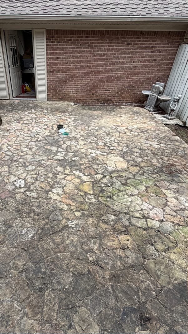 Stone patio with mildew and algae before pressure washing