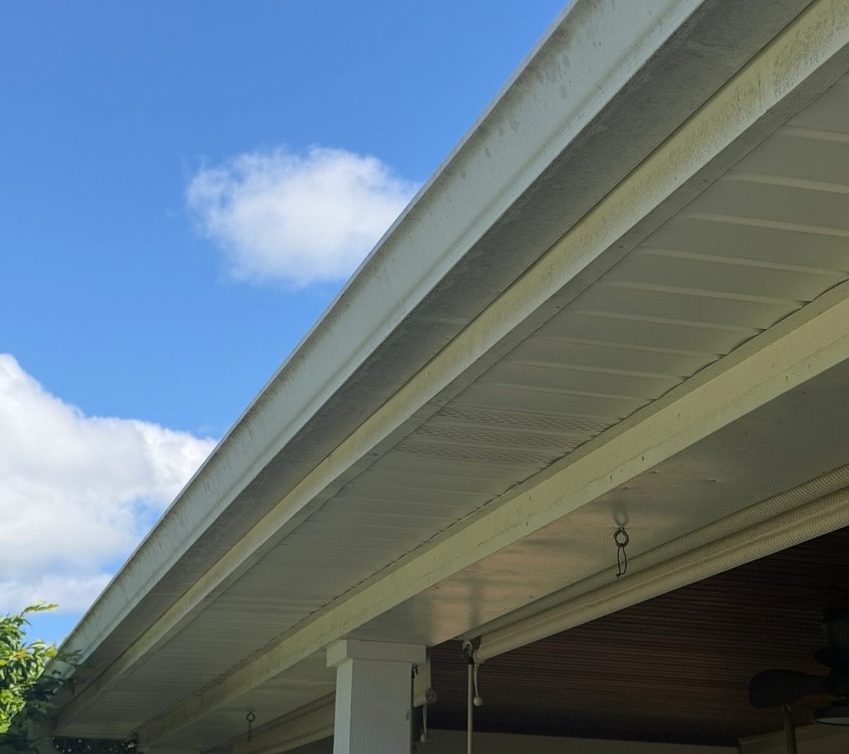 Dirty soffit and gutter before soft washing in Central Kentucky