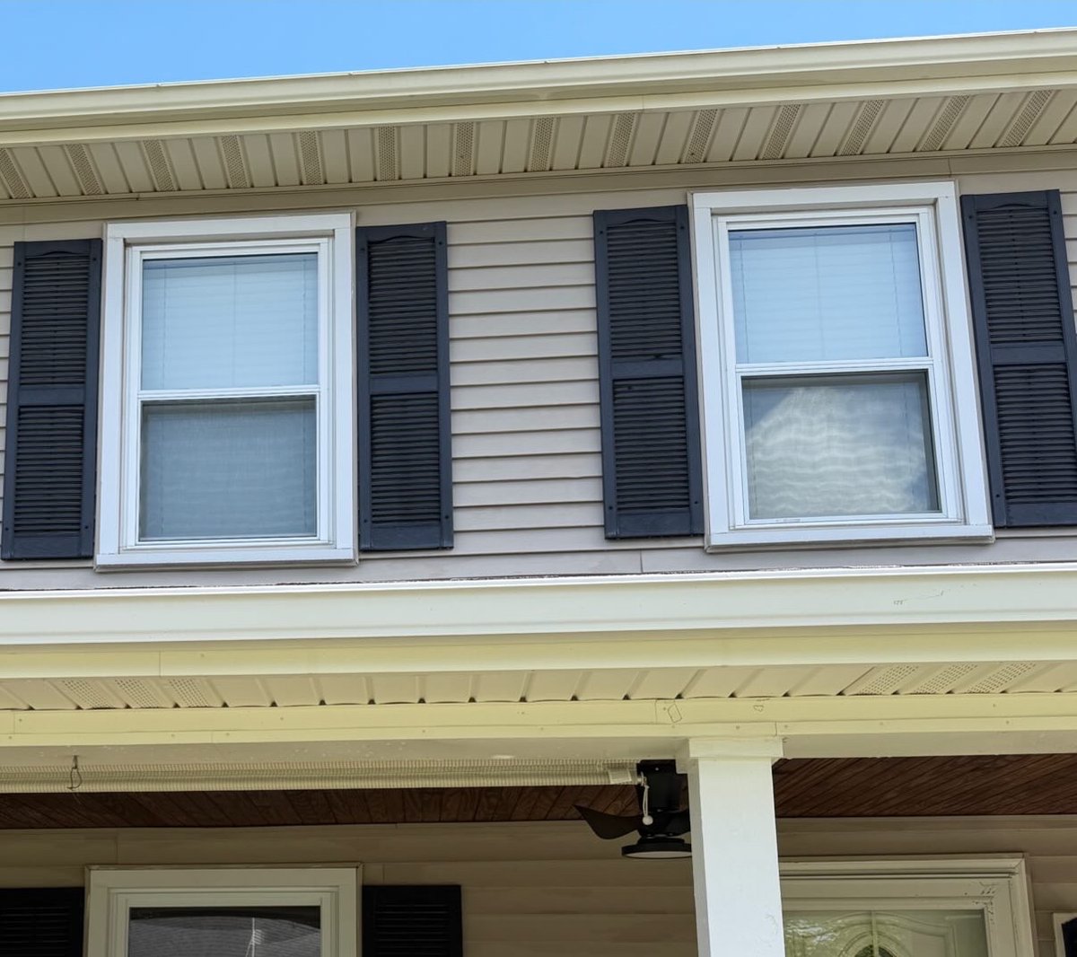 Tan vinyl siding restored after soft washing in Central Kentucky